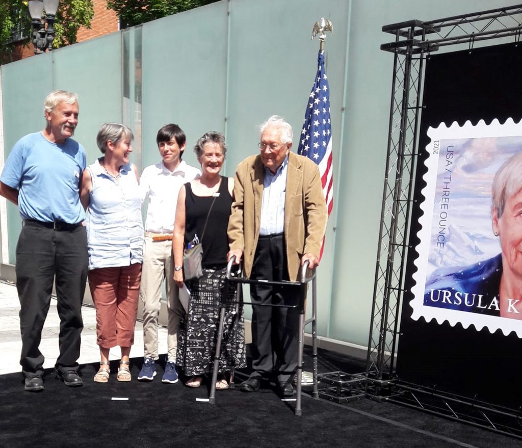 Le Guin's family beside the unveiled stamp poster.