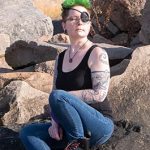 Author headshot, proudly leaning against a rock