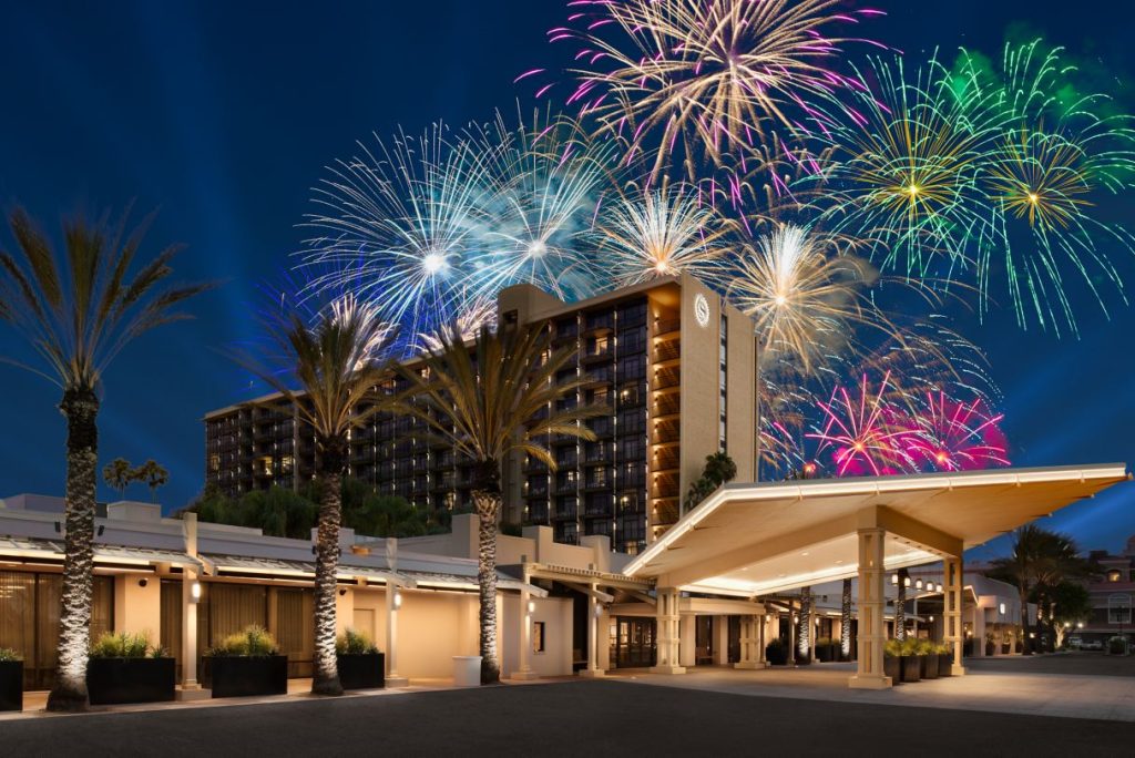 Conference Hotel exterior with fireworks in the night sky behind it.