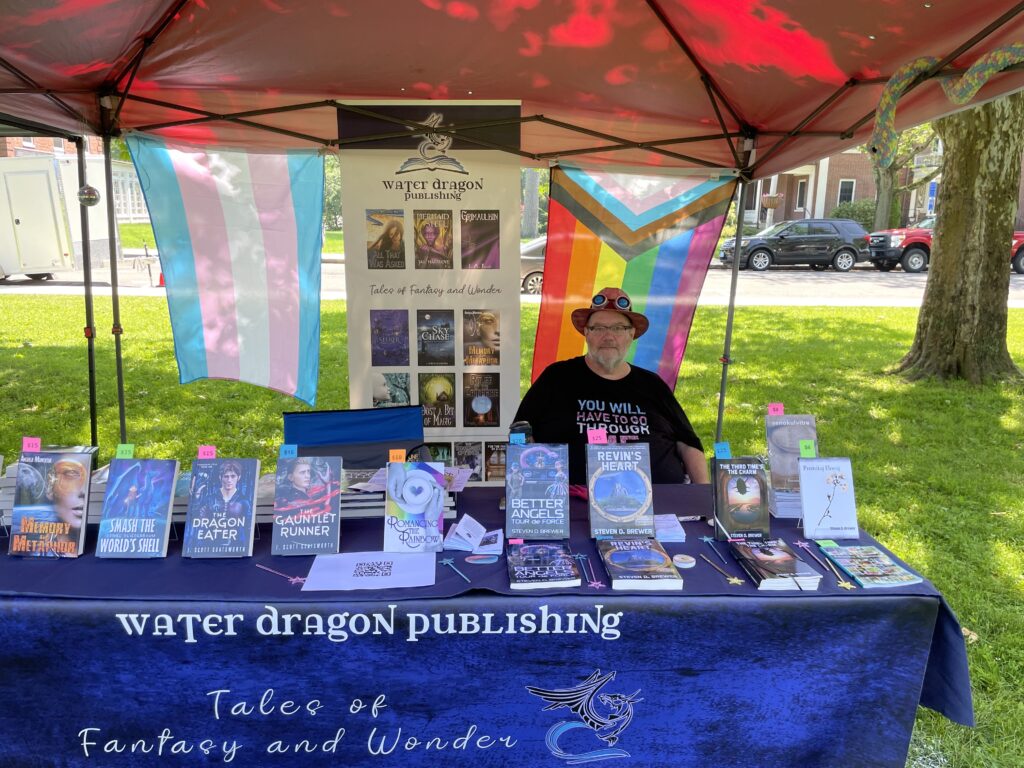 The author, selling books at the rally after the first Amherst Pride Parade on June 22, 2025.
