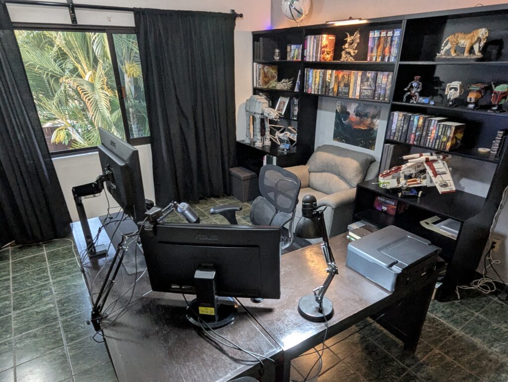 Jeff Brown's workspace, featuring dedicated design equipment and finished work on the shelves around.